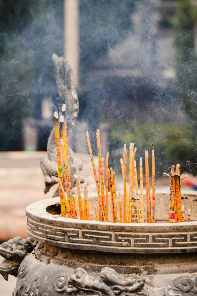 Intricate incense burner with smoking sticks captures the essence of spiritual tradition and cultural heritage.